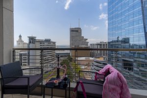 Corner balcony with city skyline, harbour views, ocean views and outdoor seating in a Cape Town CBD apartment.